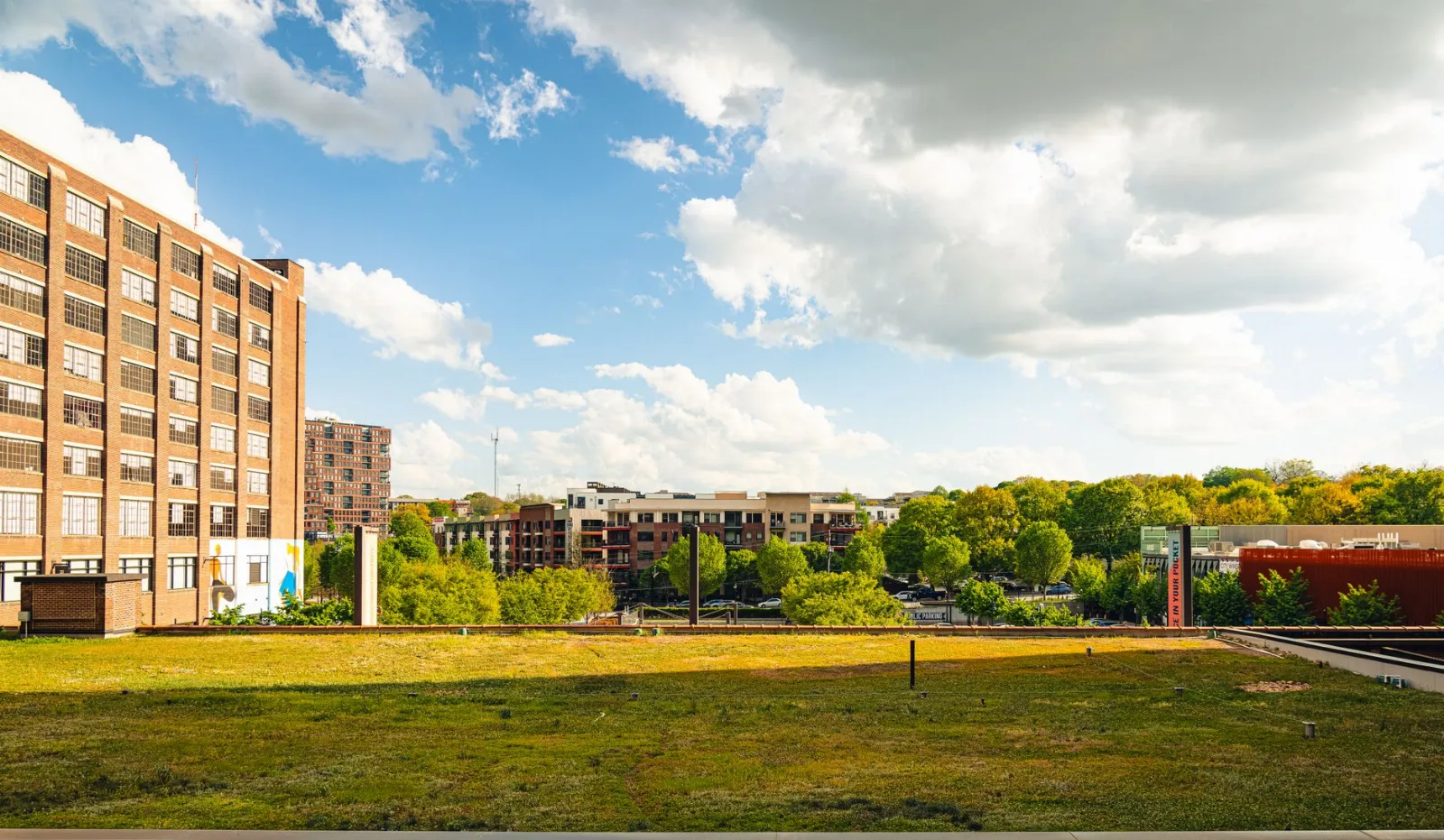 Panoramic view of Atlanta's midtown showcasing historic architecture and lush greenery under a bright sky.